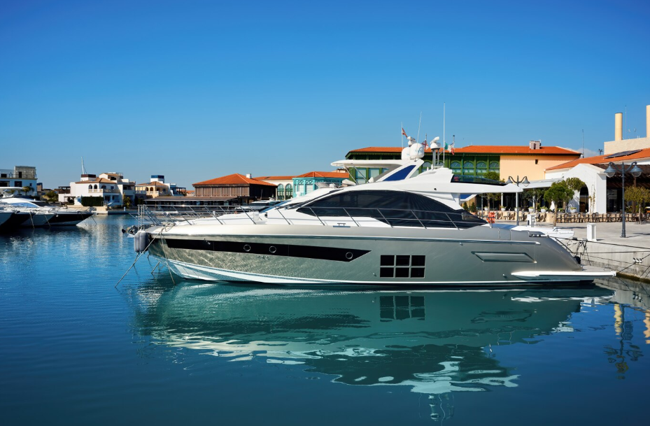 Luxury yacht docked at upscale marina with waterfront villas