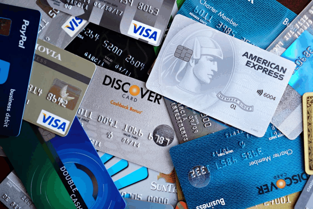 Collection of luxury credit cards including American Express, Discover, Visa, and Mastercard.